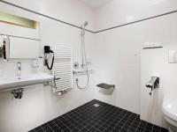 a bathroom with a sink and a shower at Hotel Vitality in Vendryně