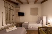 Posteľ alebo postele v izbe v ubytovaní Capolavoro Suites