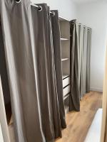a row of gray curtains in a room at Appartement vue sur l ocean in Hendaye