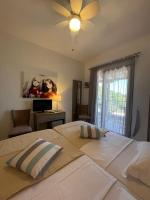 A bed or beds in a room at Koumaros Aparthotel