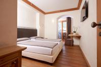 Posteľ alebo postele v izbe v ubytovaní Hotel Rezia