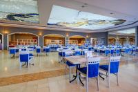 een feestzaal met tafels en blauwe stoelen bij Yasmin Bodrum Resort in Gumusluk