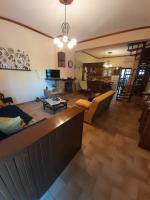 a living room with a couch and a table at Adorable 2 floors two bedroom vacation maisonette in Nea Potidaea
