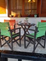 two chairs and a table on a patio at Adorable 2 floors two bedroom vacation maisonette in Nea Potidaea