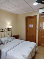 Posteľ alebo postele v izbe v ubytovaní Hotel Beatriz