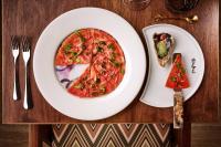 a table with a plate of pizza and a slice of pizza at ette luxury hotel & spa - Near Disney Theme Parks in Orlando