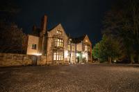 un antiguo edificio de piedra con luces por la noche en The Old Deanery - Restaurant With Rooms, en Ripon