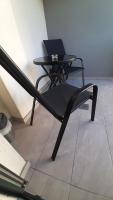 a black chair and a table with a laptop on it at Apartman 222 in Brčko