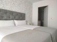 A bed or beds in a room at Second Home Arzúa apartamentos
