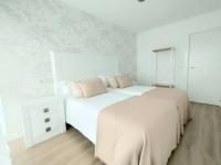 A bed or beds in a room at Second Home Arzúa apartamentos