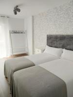 A bed or beds in a room at Second Home Arzúa apartamentos
