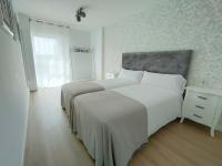 A bed or beds in a room at Second Home Arzúa apartamentos