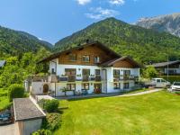 an image of a house with mountains in the background at Apartment Claudia in Vandans