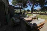 a deck with chairs and a couch and a table at Domaine d&#39;Arena Casa Zinzala in Porto-Vecchio