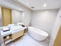 a bathroom with a sink and a tub and a toilet at Sonnien Hotel in Taipei