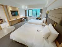 a hotel room with two beds and a television at Sonnien Hotel in Taipei