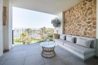 a living room with a couch and a balcony at Hotel & Spa Blau Parc in San Antonio