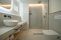 a white bathroom with a sink and a shower at Hotel & Spa Blau Parc in San Antonio