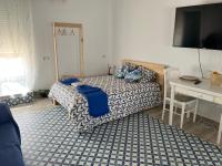 A bed or beds in a room at Alzira bonita Ático E Plaza Mayor con gran terraza