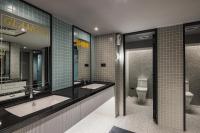 a bathroom with two sinks and a toilet at OLAH Poshtel - Taichung Station in Taichung