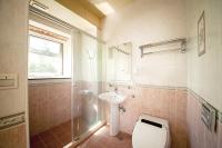 a bathroom with a toilet and a sink and a shower at Spring Villa in Dongshan