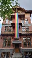 a building with a rainbow flag on the front of it at Stayokay Hostel Amsterdam Vondelpark in Amsterdam