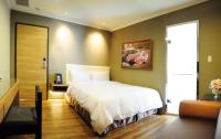 a bedroom with a large white bed in a room at Garden Hotel in Taichung