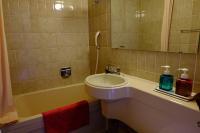 a bathroom with a sink and a bath tub at Guesthouse Sakuya in Fujikawaguchiko