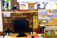 a computer monitor sitting on top of a desk at Guesthouse Sakuya in Fujikawaguchiko
