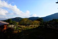 a view of a hill with mountains in the background at Guesthouse Sakuya in Fujikawaguchiko