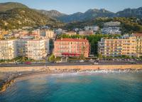 a view of the beach and buildings in a city at Best Western Premier Hotel Prince de Galles in Menton