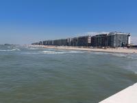 a view of a beach with buildings and condos at Appartement Blankenberge Zeedijk aan de Pier in Blankenberge