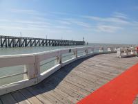 a pier with a red carpet next to the water at Appartement Blankenberge Zeedijk aan de Pier in Blankenberge