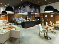 a restaurant with a person standing behind a counter at Hotel Vitality in Vendryně