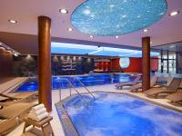 a swimming pool with a large blue tub in a hotel at Hotel Vitality in Vendryně