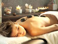 a woman laying on a towel in a spa tub at Hotel Vitality in Vendryně