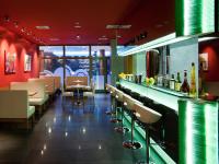 a restaurant with a bar with chairs and tables at Hotel Vitality in Vendryně