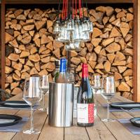 a table with two bottles of wine and glasses at MAISON de la Bonne Vie in Thérondels