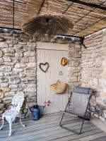 a porch with a chair and a door with a basket at chambre d&#39;hôtes Et Puis Voilà! in Murs