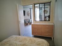 a bedroom with a dresser with a mirror and a window at La Terrasse Ensoleillée de Sausset : Le Citronnier in Sausset-les-Pins