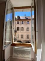 an open window with a view of a building at LEtage - Large T3 in the heart of the Old Town of Annecy in Annecy