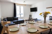 a dining room with a table with plates and wine glasses at Cacatoès in Saint-Aignan