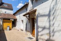 a building with a wooden door on the side of it at Cacatoès in Saint-Aignan