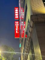 a building with neon signs on the side of it at Yomi Hotel - ShuangLian MRT in Taipei