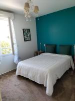 - une chambre avec un lit blanc et un mur bleu dans l&#39;établissement Maison bijou plage, juan les Pins-Antibes, à Antibes