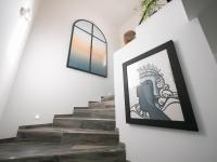 a stairway with a framed picture on the wall at LES ROCHES DE BAUDISSET in Saint-Paul-en-Forêt