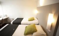 a small room with two beds and a desk at Campanile Nîmes Sud - Caissargues in Caissargues