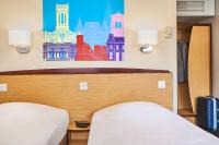 Una cama o camas en una habitaci&oacute;n de Kyriad Direct Lyon Sud - Chasse-Sur-Rh&ocirc;ne