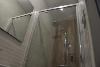 a shower with a glass door in a bathroom at le p&#39;tit studio de Segré centre in Segré