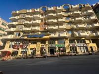 a large apartment building on a city street at Paradise Hill Compound in Hurghada